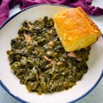 Southern turnip greens in a bowl with a slice of cornbread