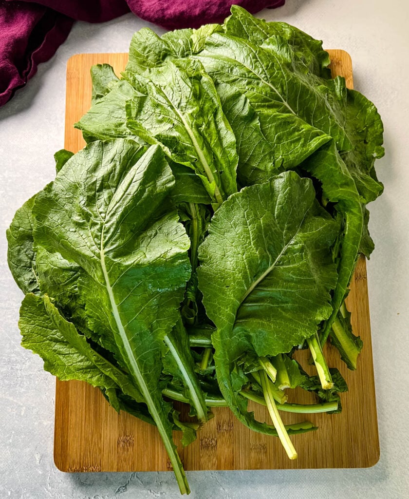 fresh turnip greens on a cutting board