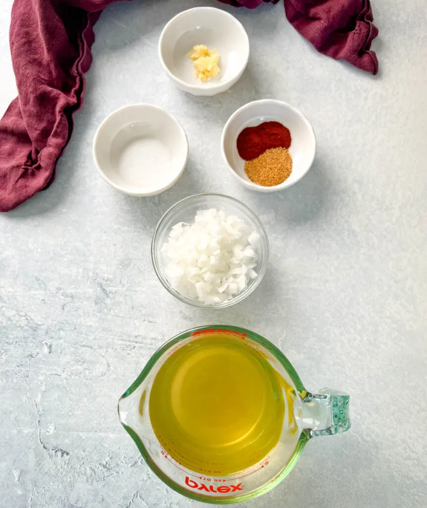 garlic, chopped onions, spices, sugar, and broth in separate bowls