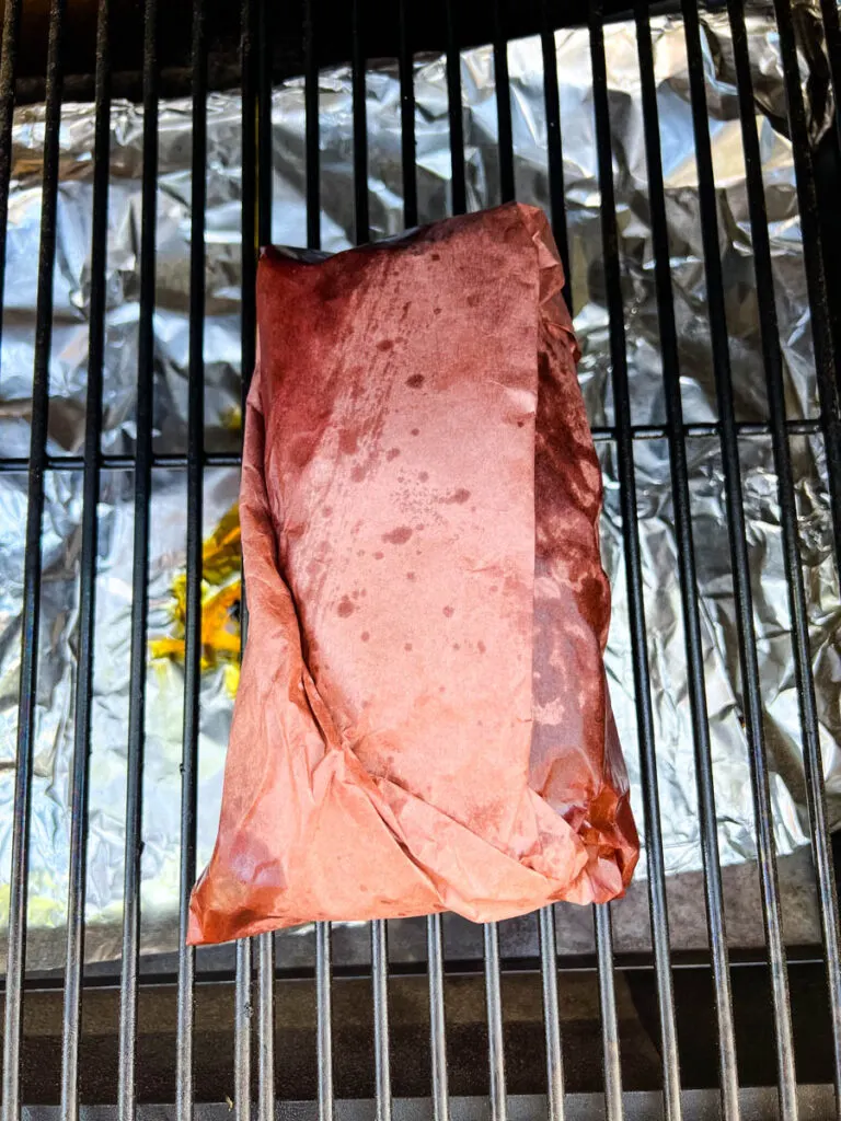 smoked brisket wrapped in butcher paper on a Traeger pellet grill