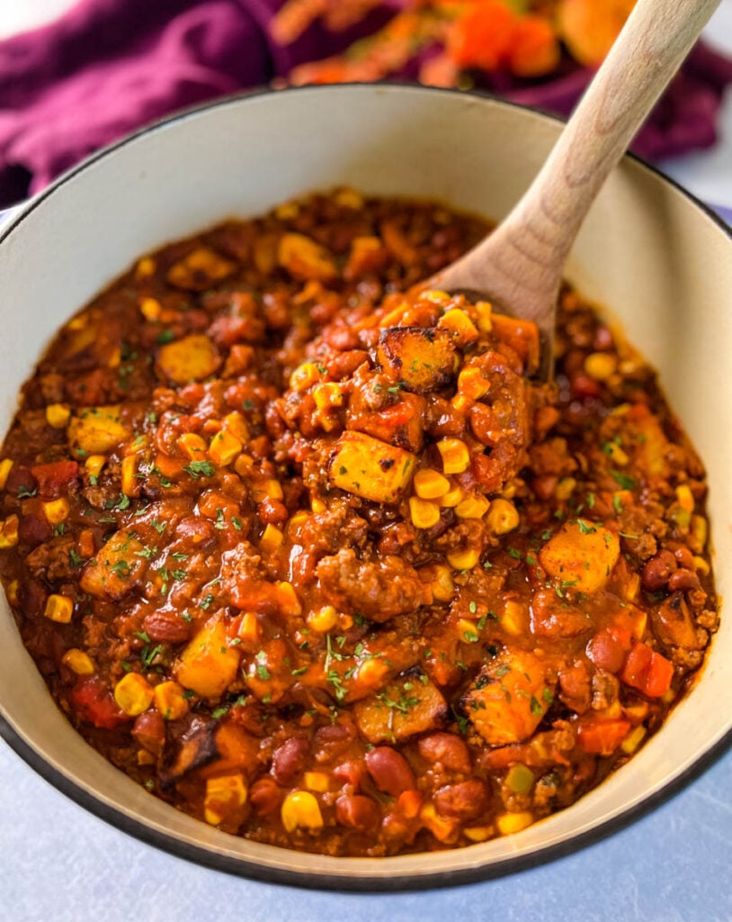 a large wooden spoonful of butternut squash chili