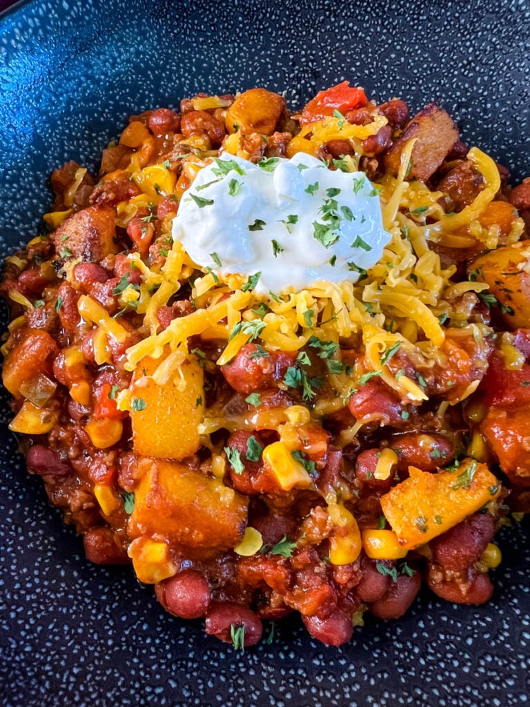 butternut squash chili in a black bowl