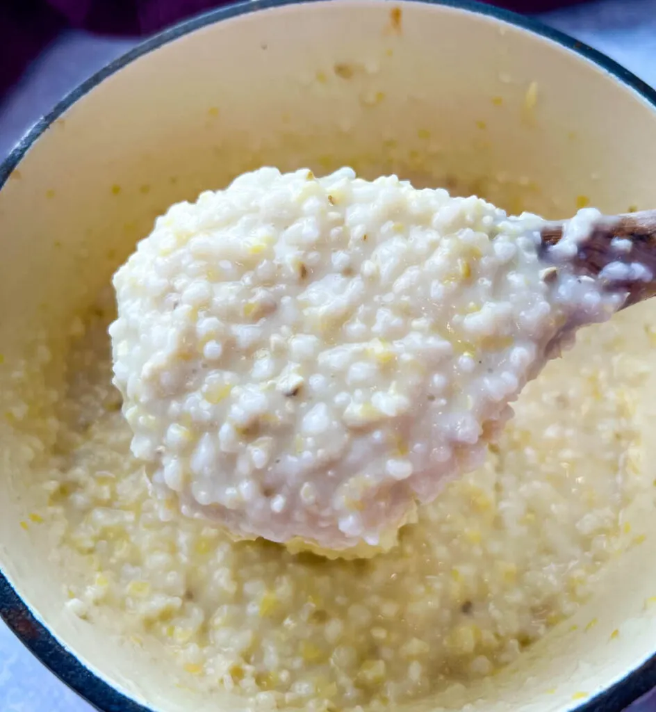 cooked grits in a pot with butter and cheese