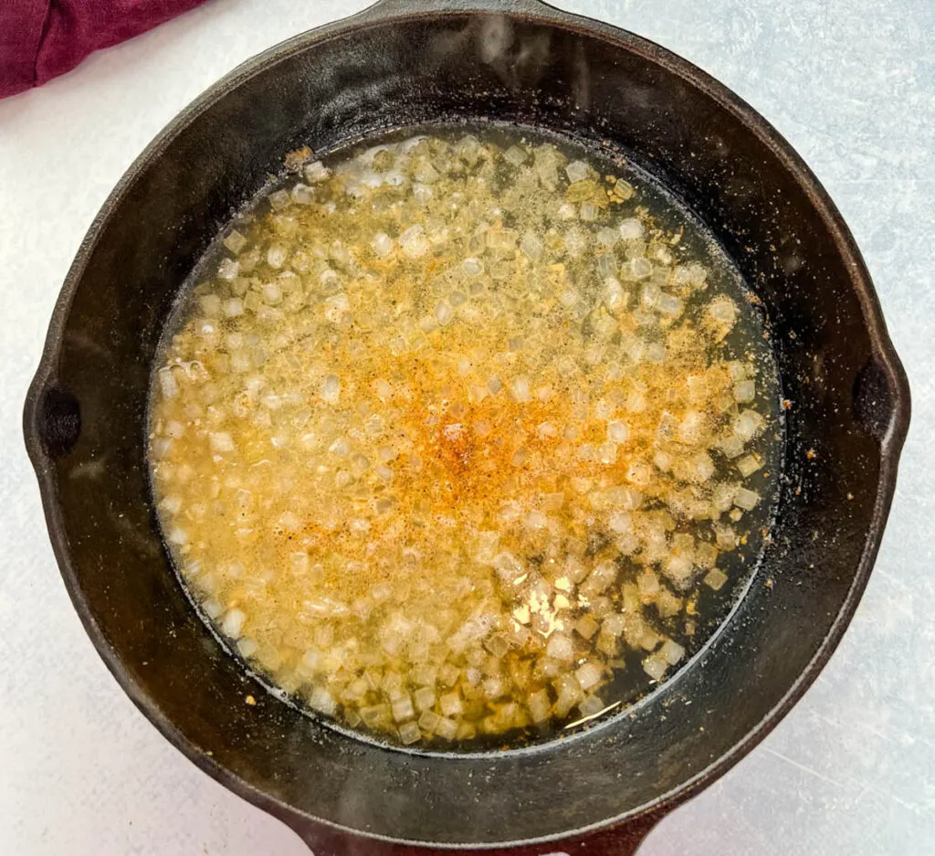 cooked onions and broth in a cast iron skillet