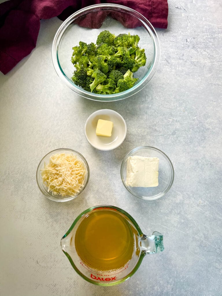 broccoli, butter, cream cheese, parmesan cheese, and broth in separate bowls