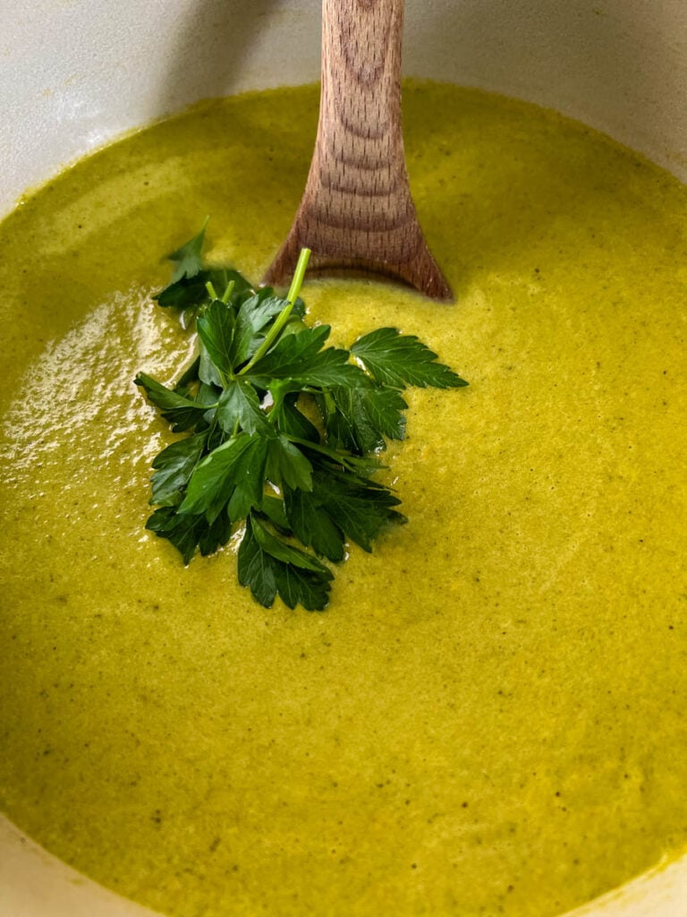 roasted creamy poblano pepper soup in a Dutch oven with a wooden spoon