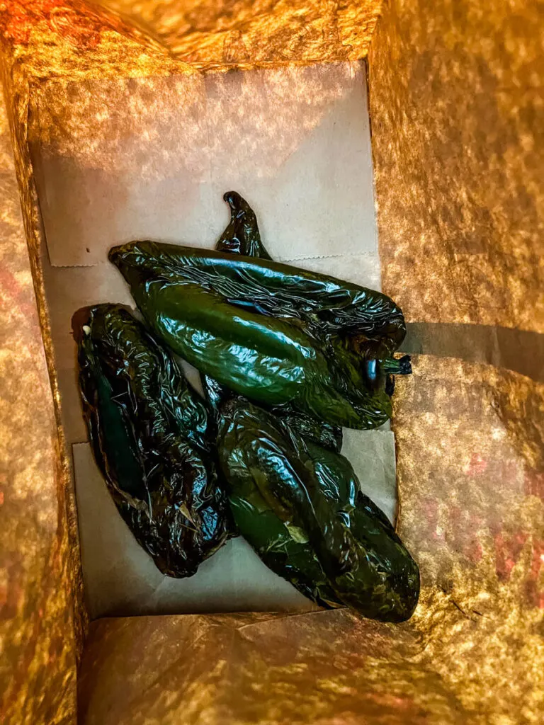 roasted poblano peppers in a paper bag