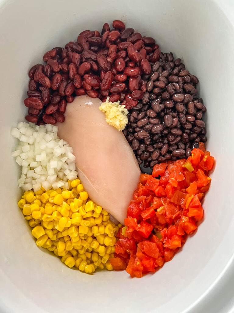 chicken breasts, beans, onion, tomatoes, and garlic in a slow cooker Crockpot