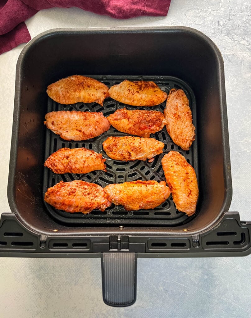 raw seasoned chicken wings in an air fryer