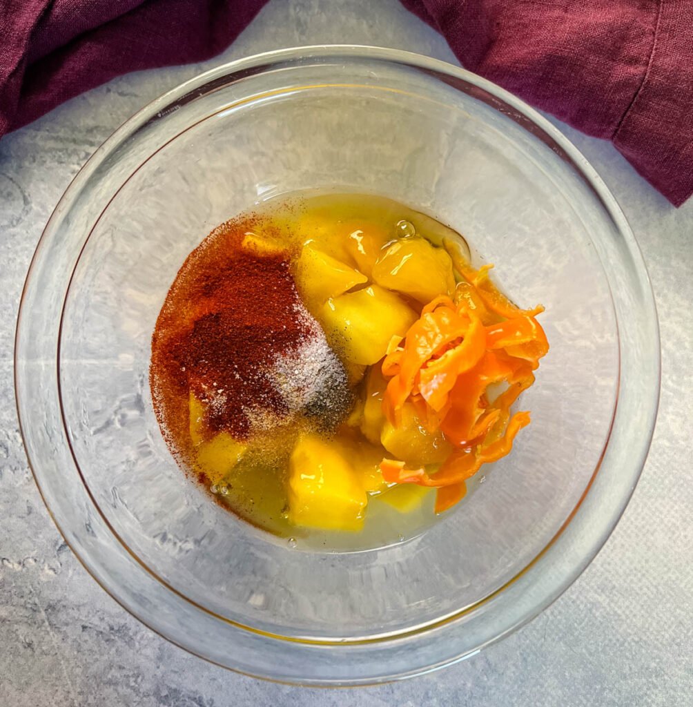 mango, spices, habanero, and honey in a glass bowl