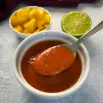 mango habanero sauce in a white bowl with a spoon