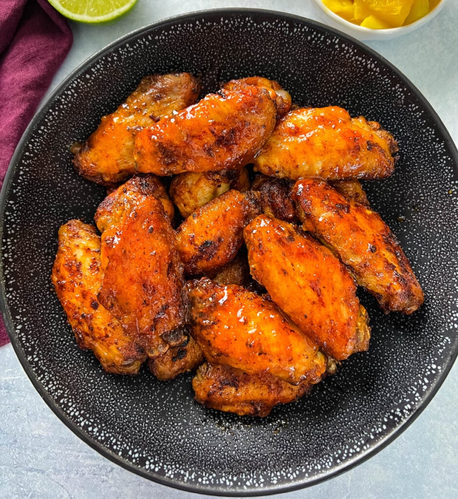 mango habanero wings in a black bowl