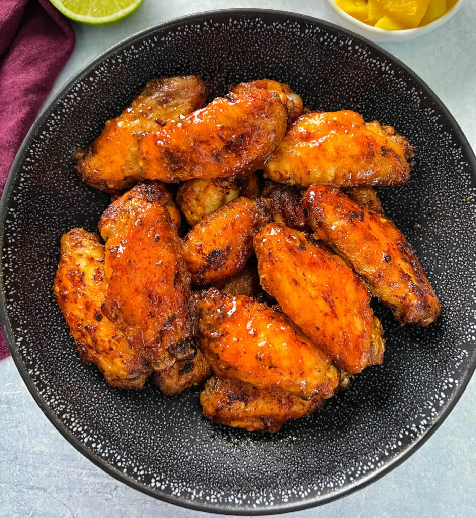 mango habanero wings in a black bowl