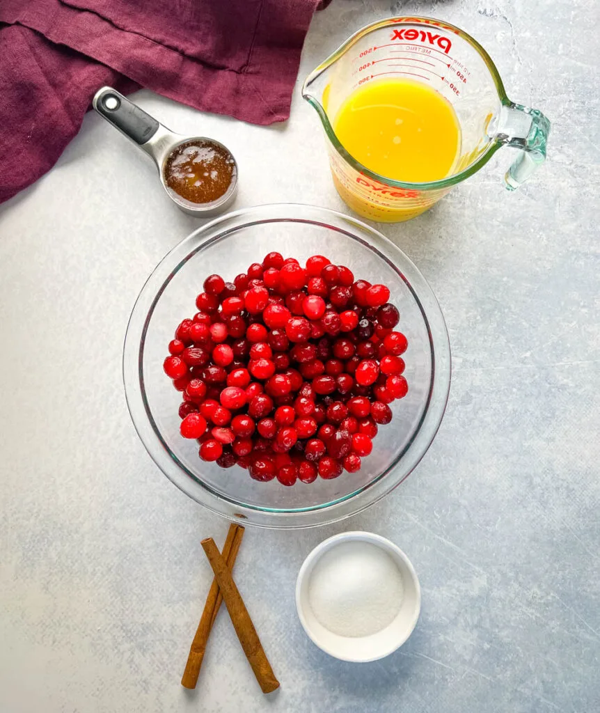 cranberry sauce, cinnamon, sugar, honey, and orange juice in separate bowls