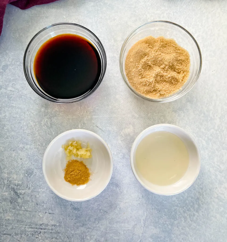 soy sauce, brown sugar, spices, and rice vinegar in separate white bowls