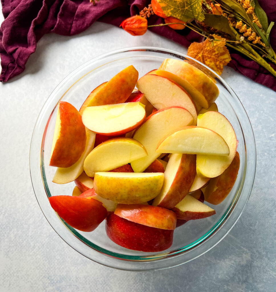 gala and honeycrisp apples sliced in a glass bowl
