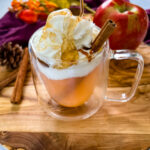 caramel apple spice cider Starbucks with whipped cream in a glass mug