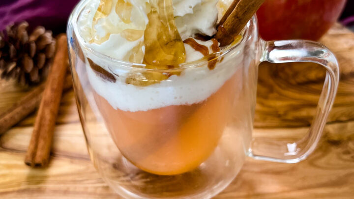caramel apple spice cider Starbucks with whipped cream in a glass mug