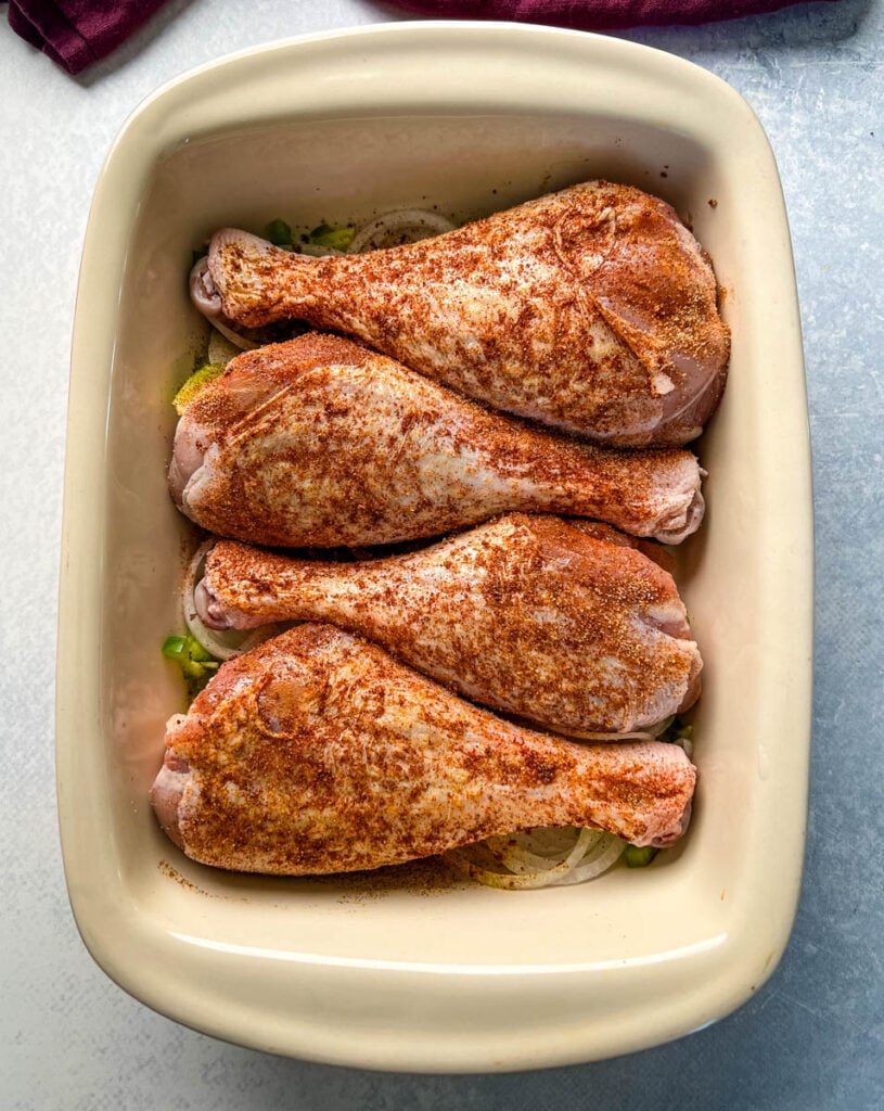raw seasoned turkey legs in a baking dish