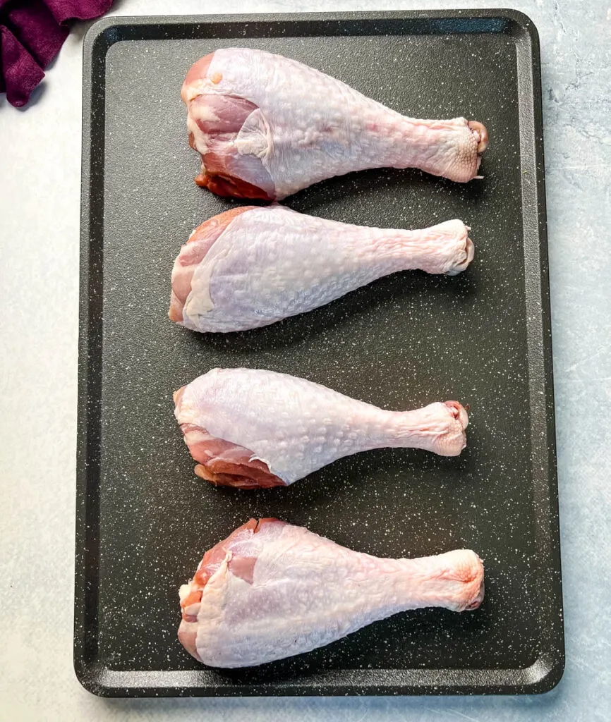 raw turkey legs on a flat surface