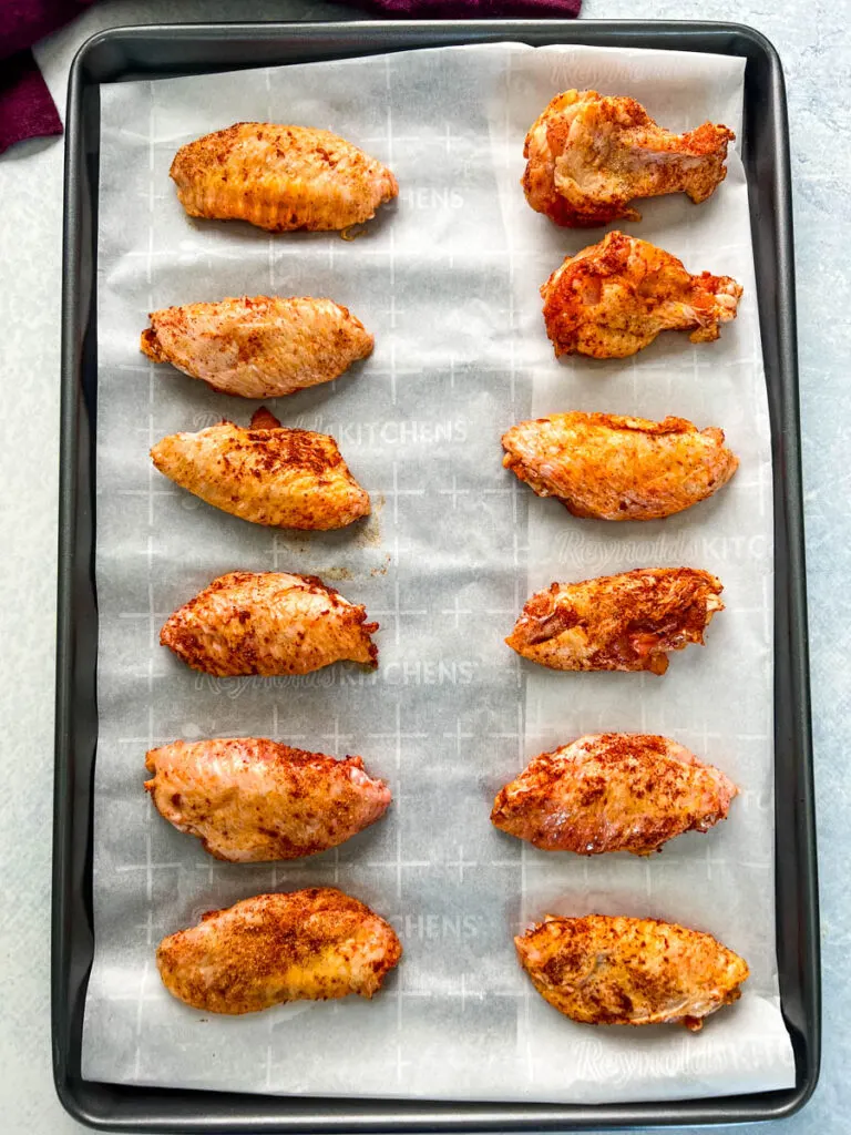 raw chicken wings on a sheet pan