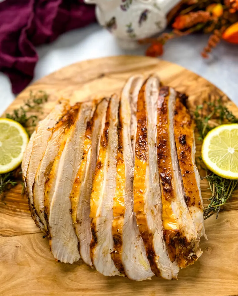 slices of Crockpot slow cooker turkey breast on a cutting board