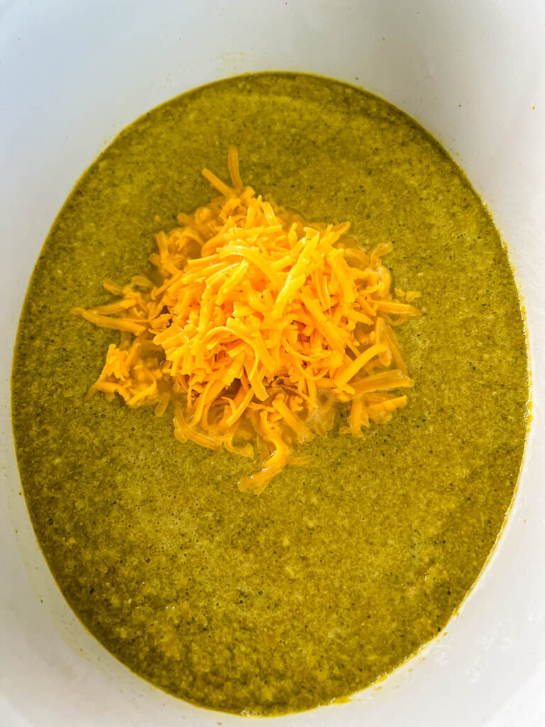 broccoli cheese soup in a Crockpot with shredded cheddar
