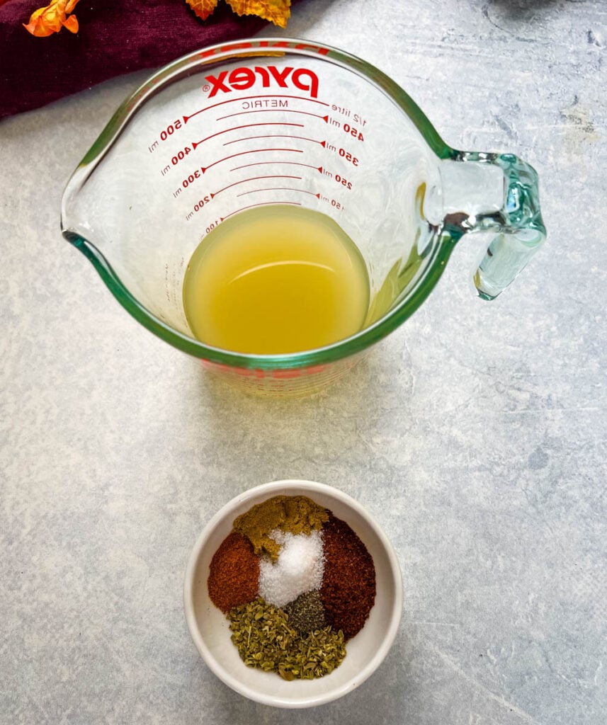 broth and chili seasoning spices in separate glass bowls