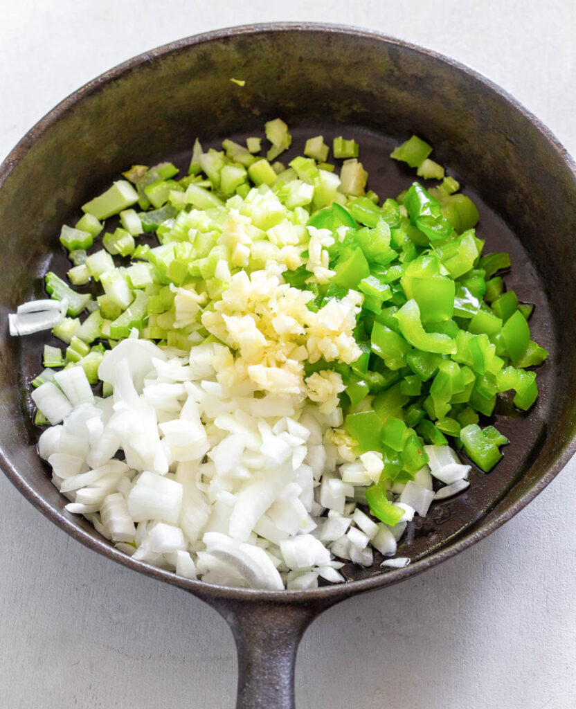 chopped celery, garlic, onions, and green peppers in a cast iron skillet