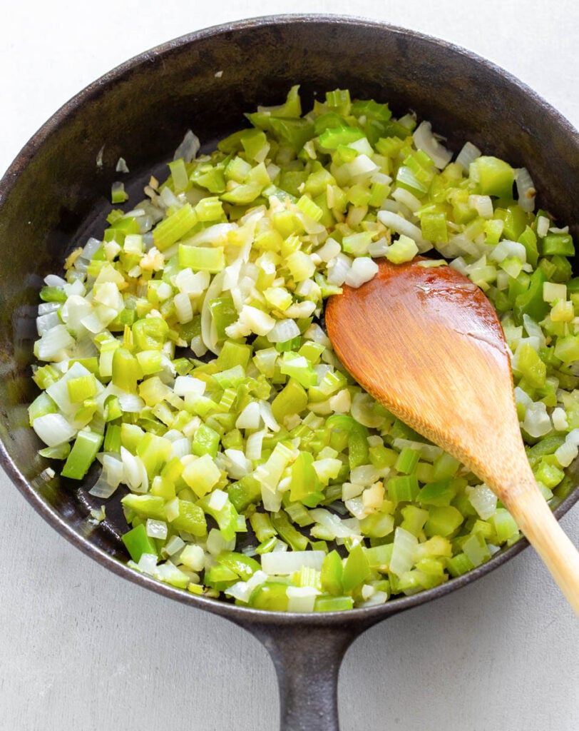 chopped celery, garlic, onions, and green peppers in a cast iron skillet