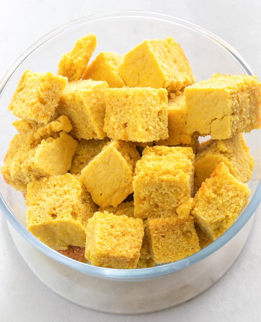 day old cornbread cut into cubes in a bowl