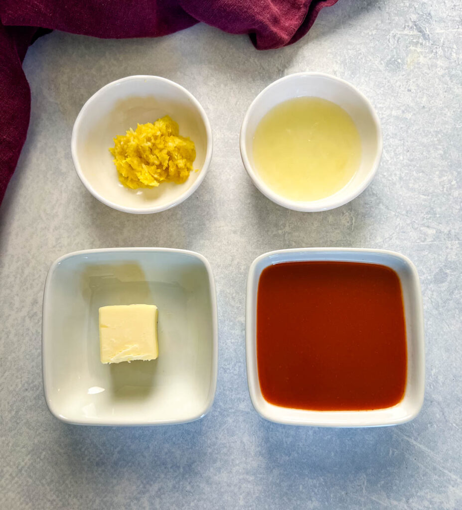 lemon zest, lemon juice, butter, and hot sauce in separate white bowls