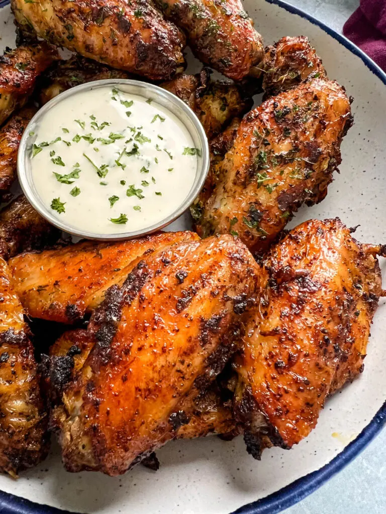 naked chicken wings in a bowl with ranch dressing