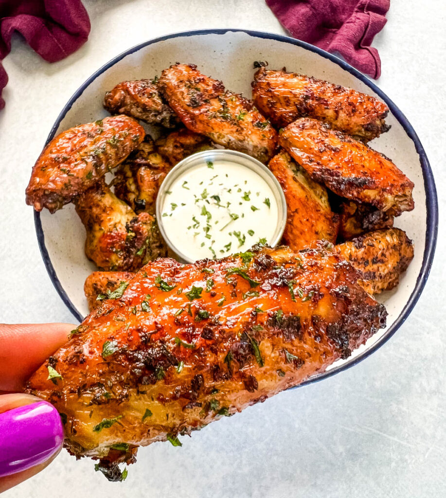 person holding naked chicken wing