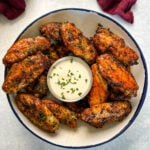 naked chicken wings in a bowl with ranch dressing