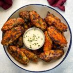 naked chicken wings in a bowl with ranch dressing