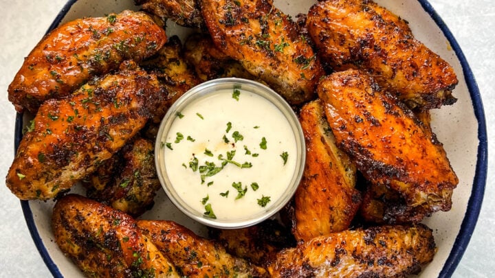 naked chicken wings in a bowl with ranch dressing