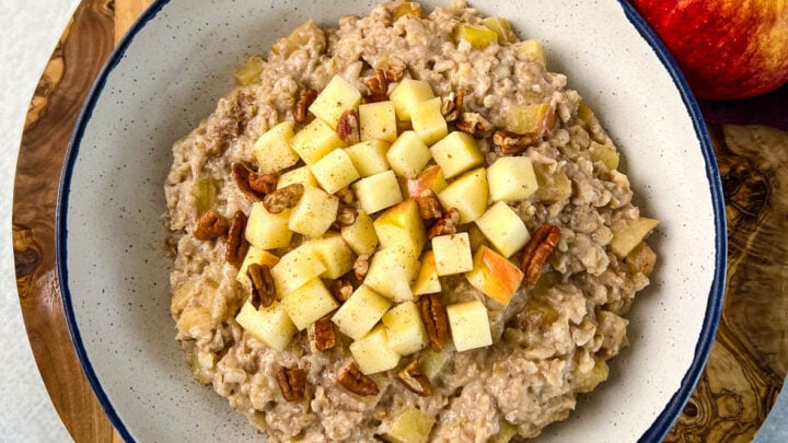 slow cooker crockpot apple oatmeal in a bowl with pecans