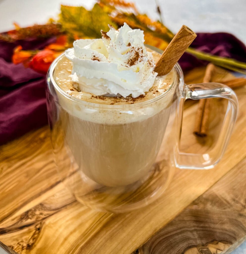 sugar free pumpkin spice latte in a mug with whipped cream and cinnamon