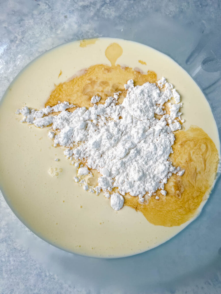 heavy whipping cream, powdered sweetener, and vanilla in a glass bowl