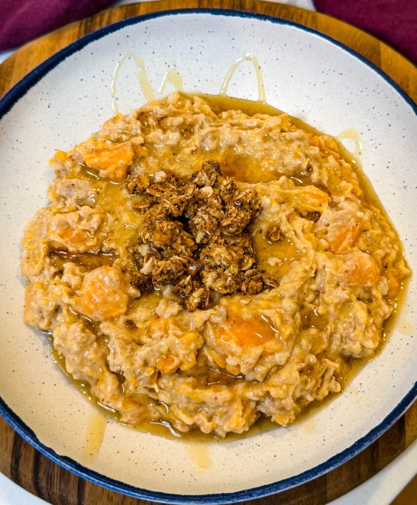 sweet potato oatmeal in a white bowl drizzled with honey and granola