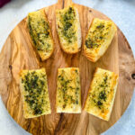 air fryer garlic bread on a wooden cutting board