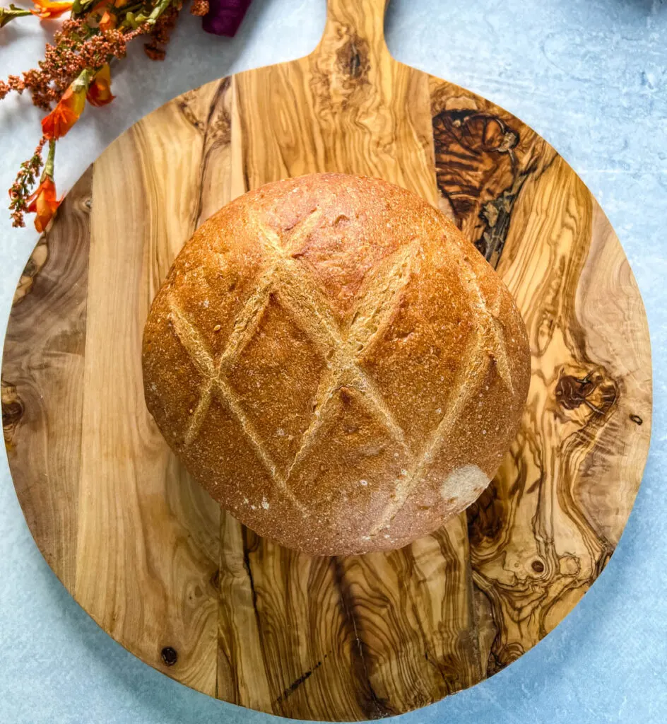 sourdough bread loaf on a wooden cutting board