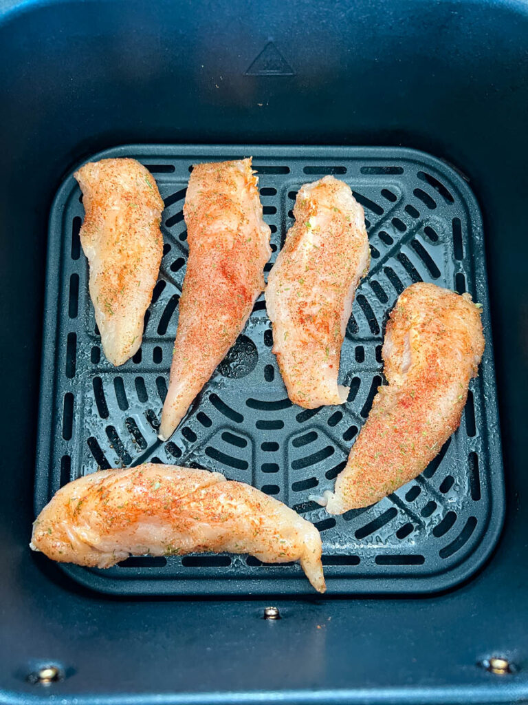 raw chicken tenders in an air fryer