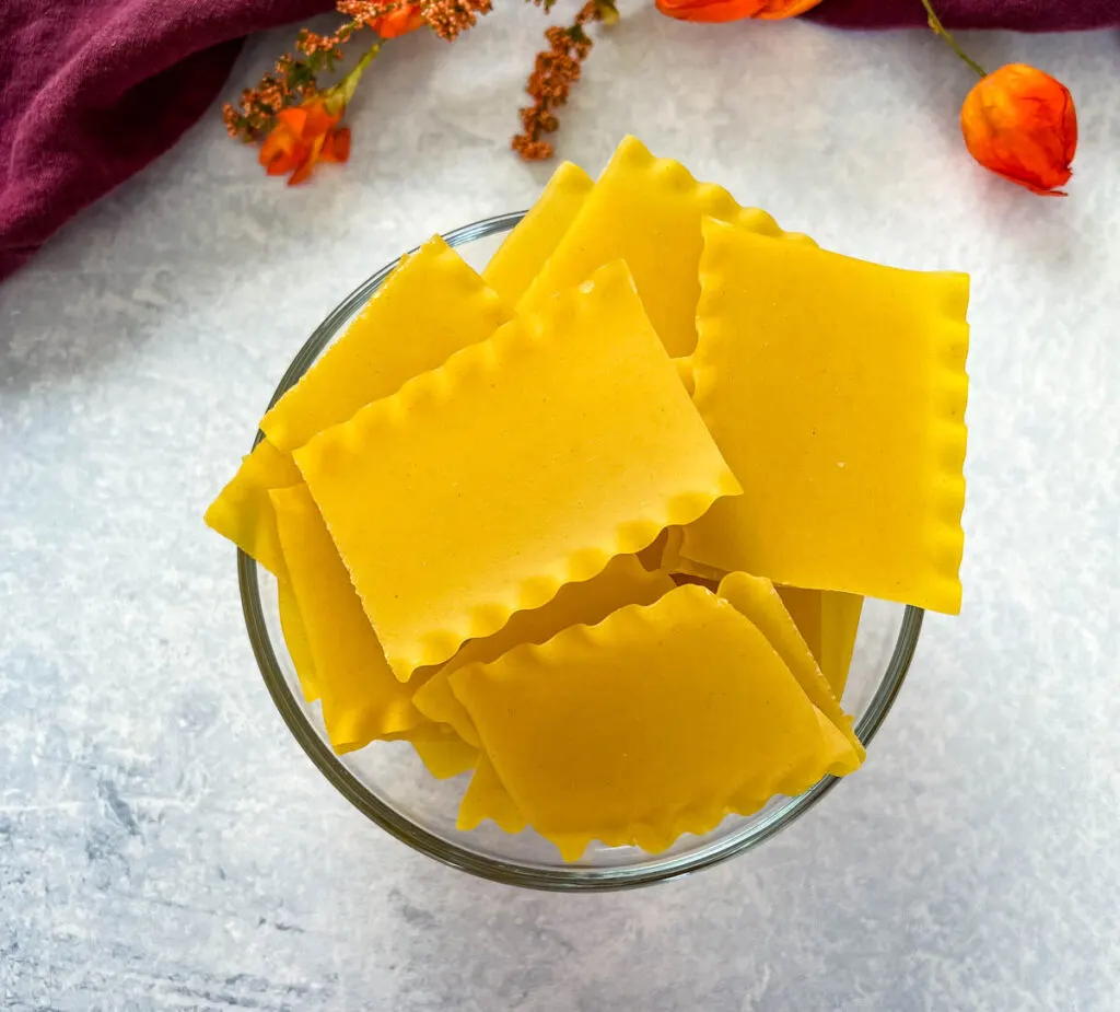 uncooked lasagna pasta in a glass bowl