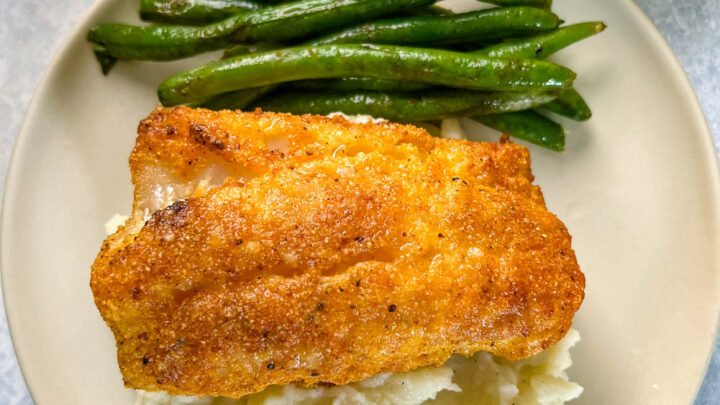 lemon pepper fish, mashed potatoes, and green beans on a plate