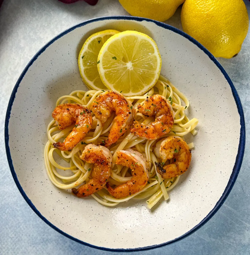 lemon pepper shrimp over pasta with fresh lemon