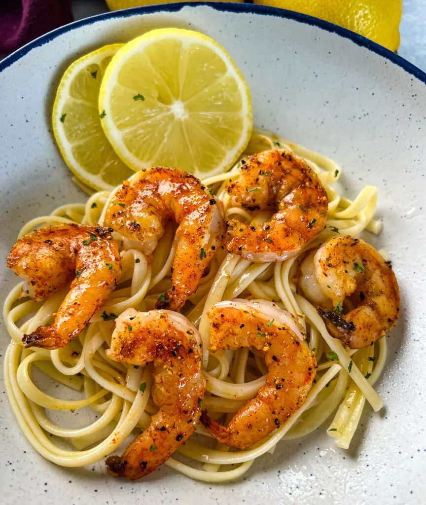 lemon pepper shrimp over pasta with fresh lemon