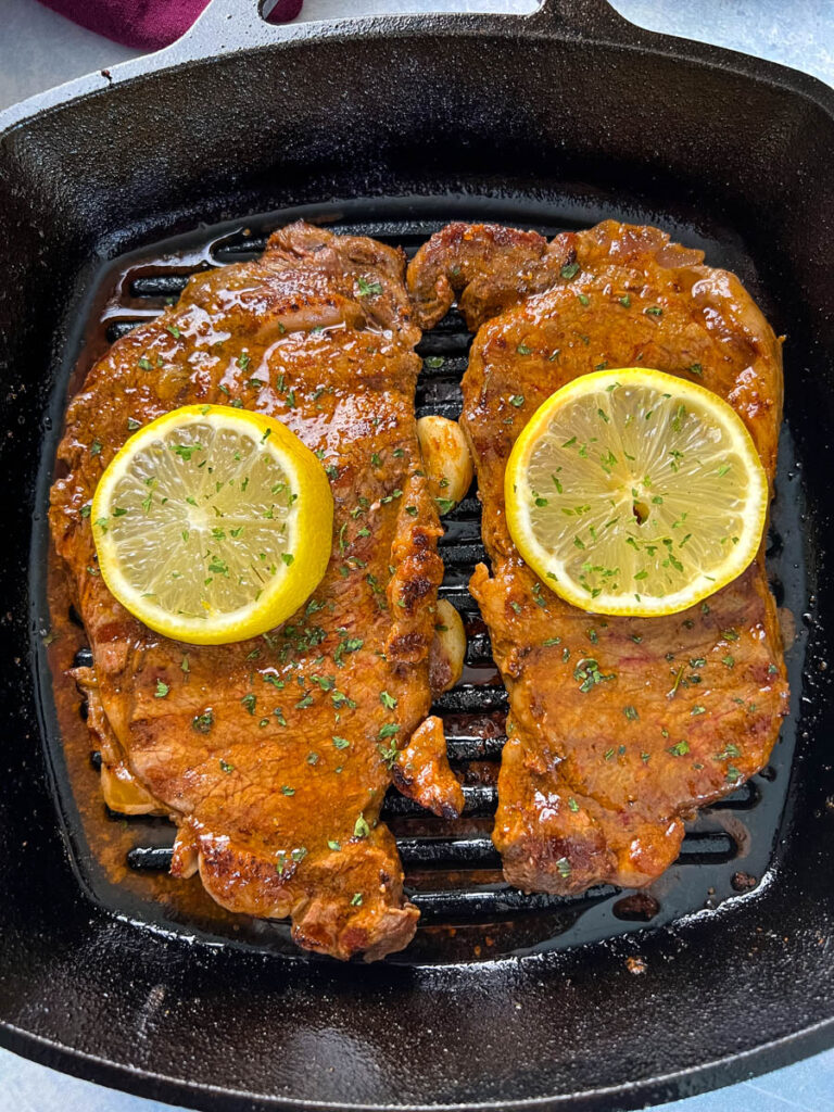 lemon pepper steak in a cast iron skillet