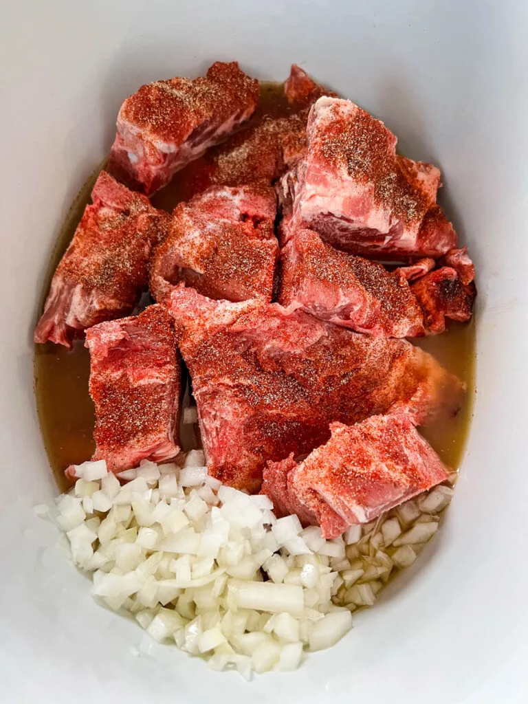 pork neck bones, onions, and broth in a Crockpot slow cooker